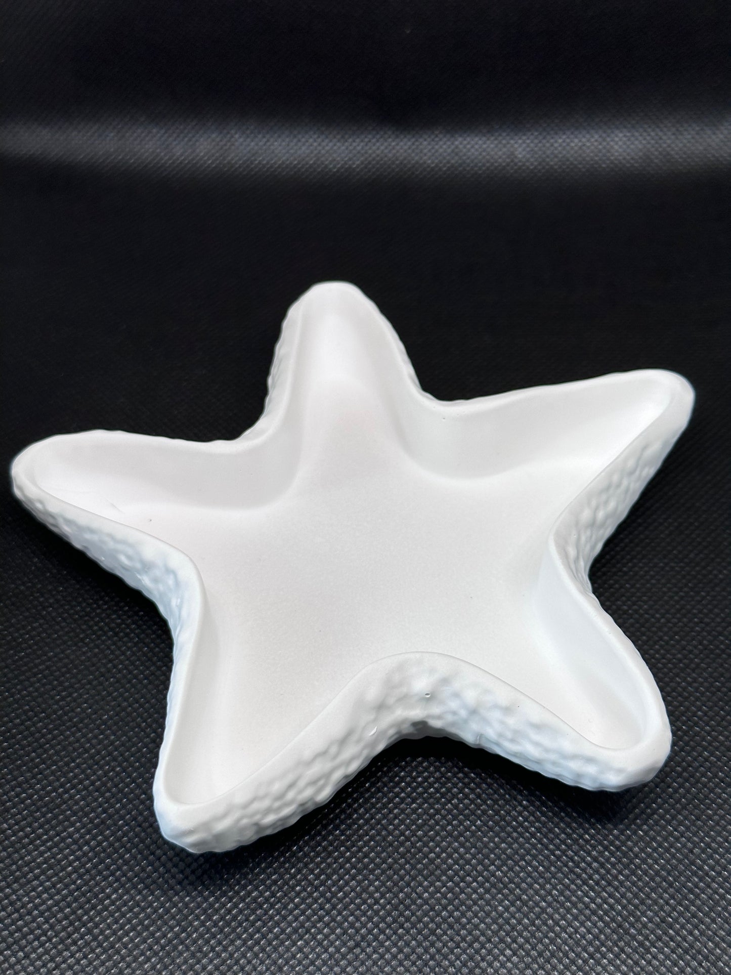 Starfish tray on black background - angle shot from above