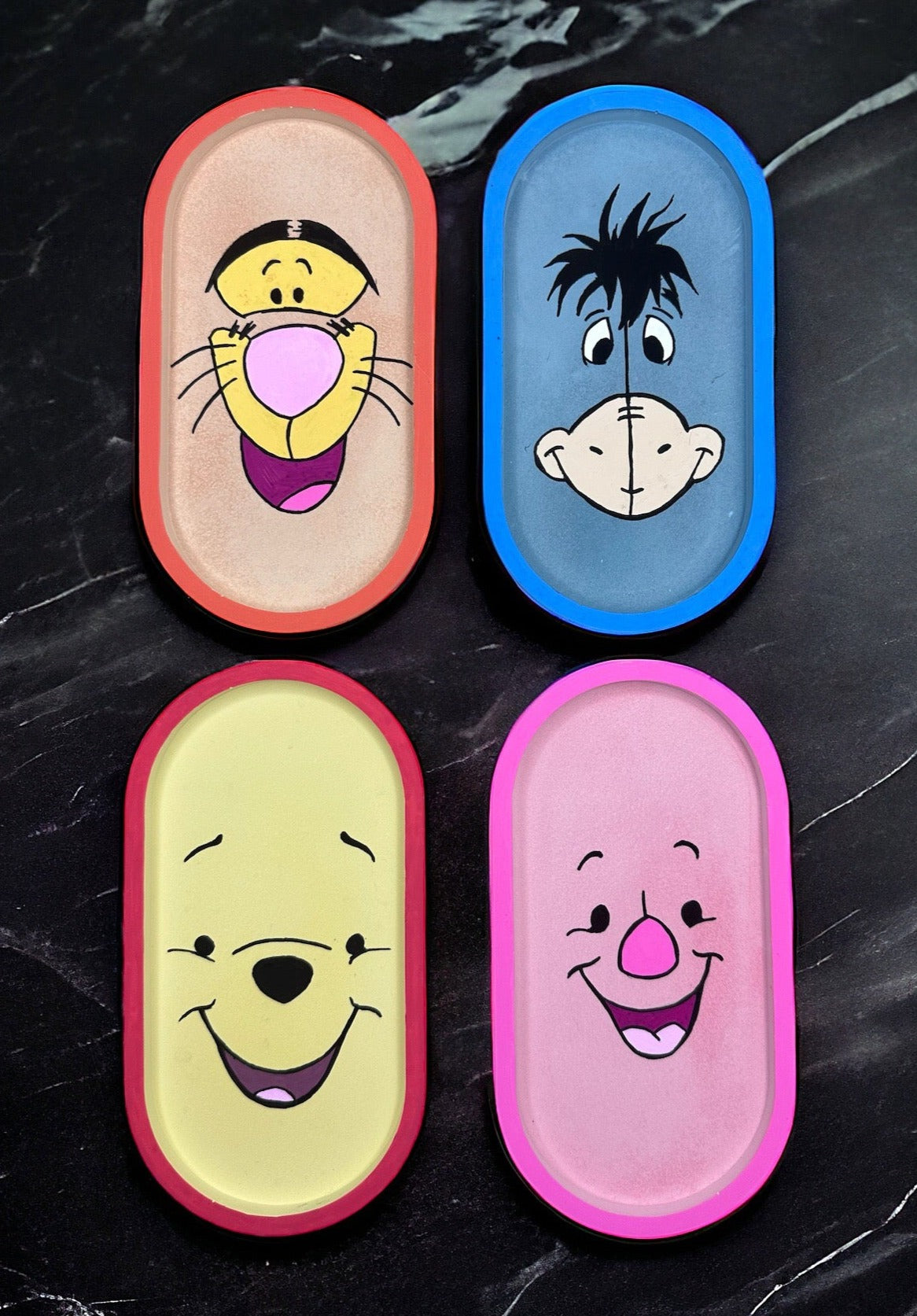 tigger, piglet, eeyore and pooh on black marble background